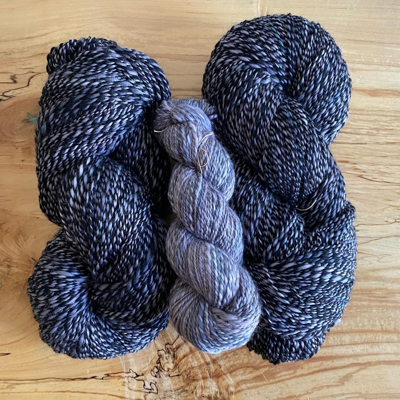 three skeins of handspun grey and black yarn