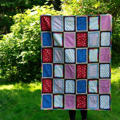 a person holds up a pop-tart quilt