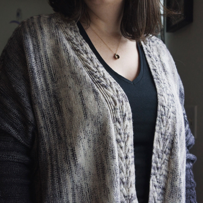 a greyscale, open-front knitted cardigan